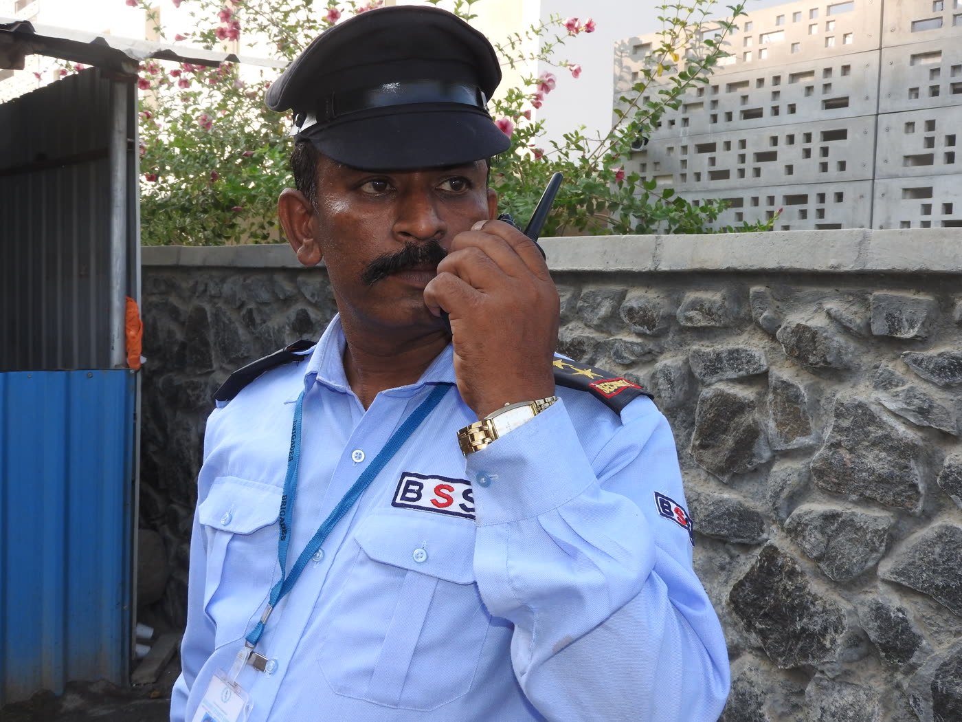 A BSS guard speaking on a two-way radio