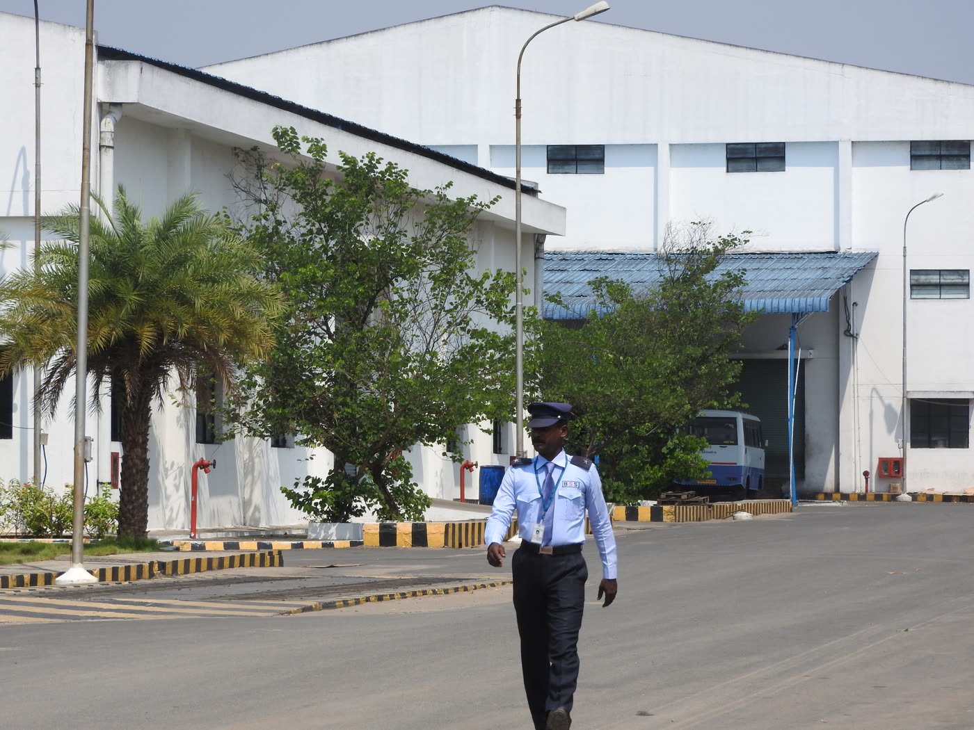 A BSS guard walking his rounds on a factory campus road