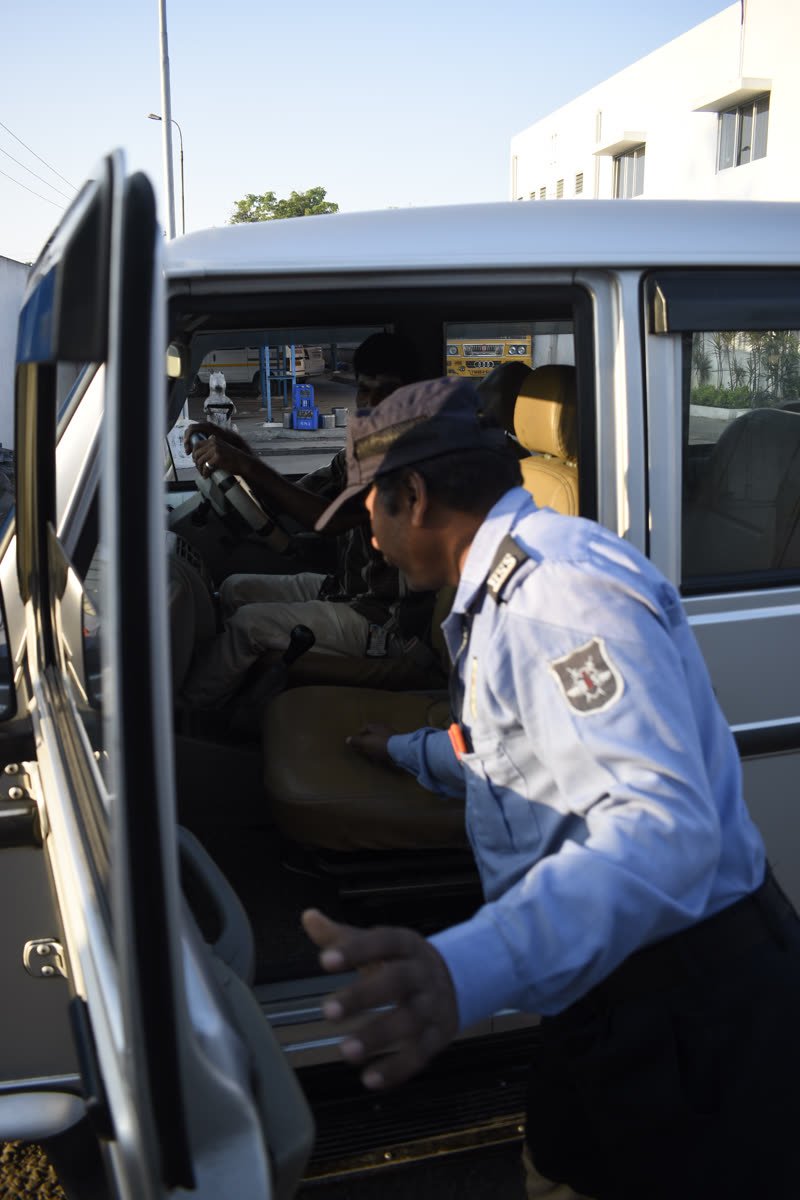 A BSS guard checking a vehicle at a site entrance